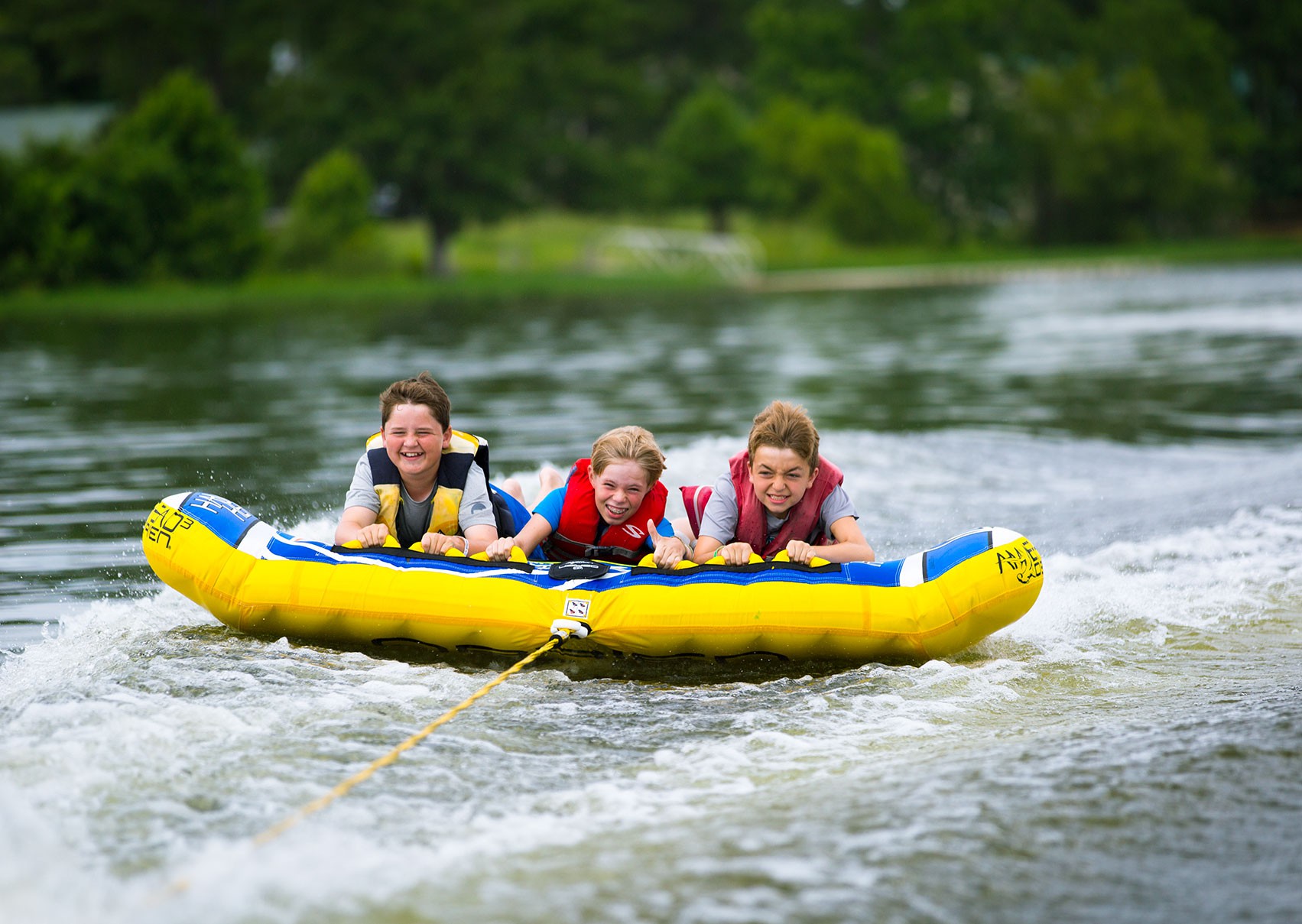 image of kids tubing on the lake